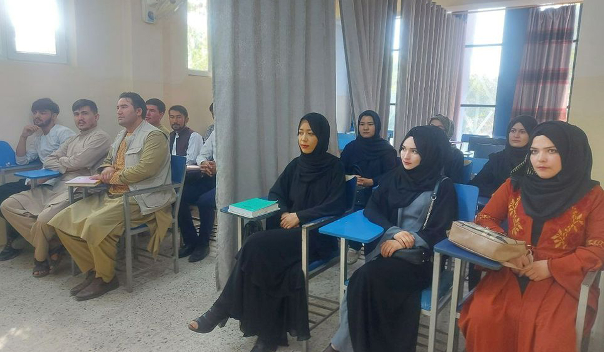 A curtain divides male, female students as Afghan universities reopen
